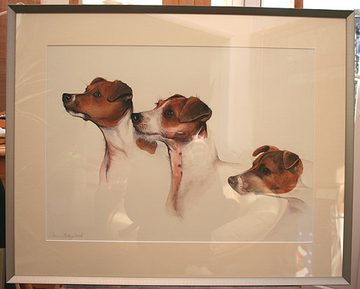 Photograph of a framed watercolour painting of three Jack Russell Terriers, by Joanna Culley